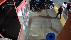 WATCH:  Newly released video shows a suspect driving off with a police officer in the car